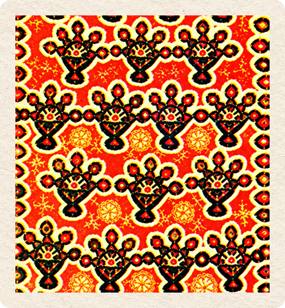 A block-printed textile in red, yellow and black, patterned with rows of oil lamps